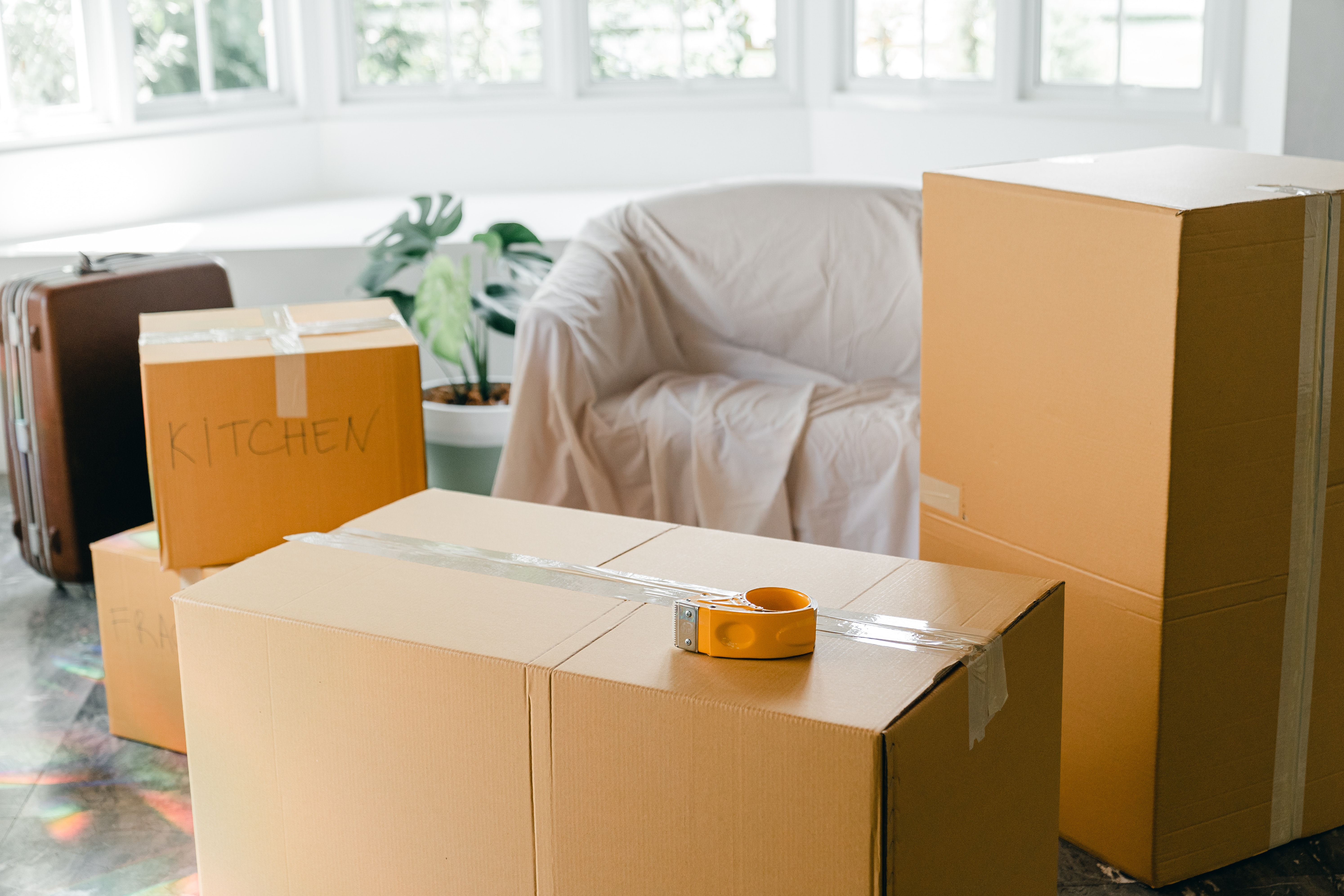 stock photo featuring moving boxes, unpacked living room in new home.