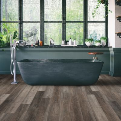 luxury vinyl plank floors in a Vermont bathroom with a dark green tub